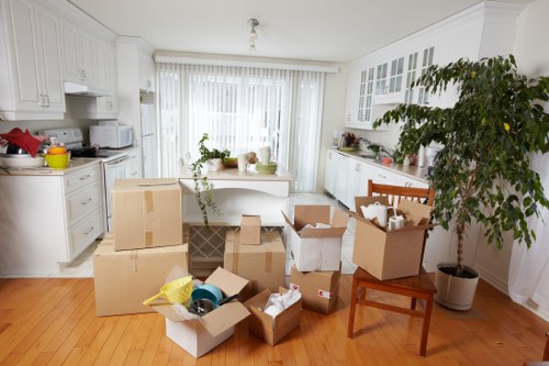Local removals team handling furniture in an East London flat