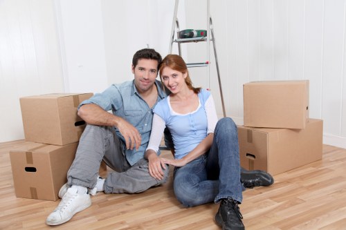 Professional movers handling boxes and furniture in an East London property